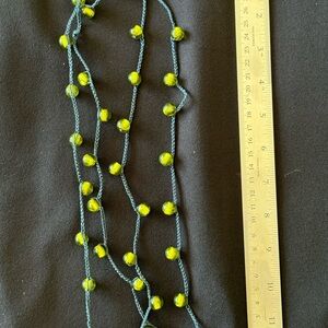 Long strand of green tiger eye beads.